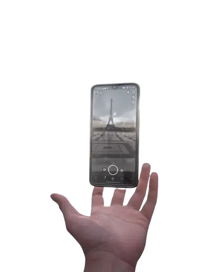 a man holding a floating phone with snapchat open, ready to take a picture of the eiffel tower